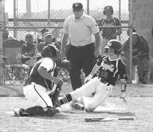 Catcher tagging a player sliding into the home plate as the Umpire audience and other team members watch. 