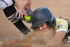 Player sliding to third base getting tagged out