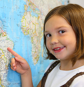 Female student points at a world map